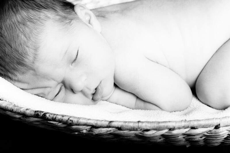 a black and white photo of a newborn baby